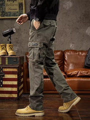 Angled view of gray cargo pants with a large flap thigh pocket and straight legs.