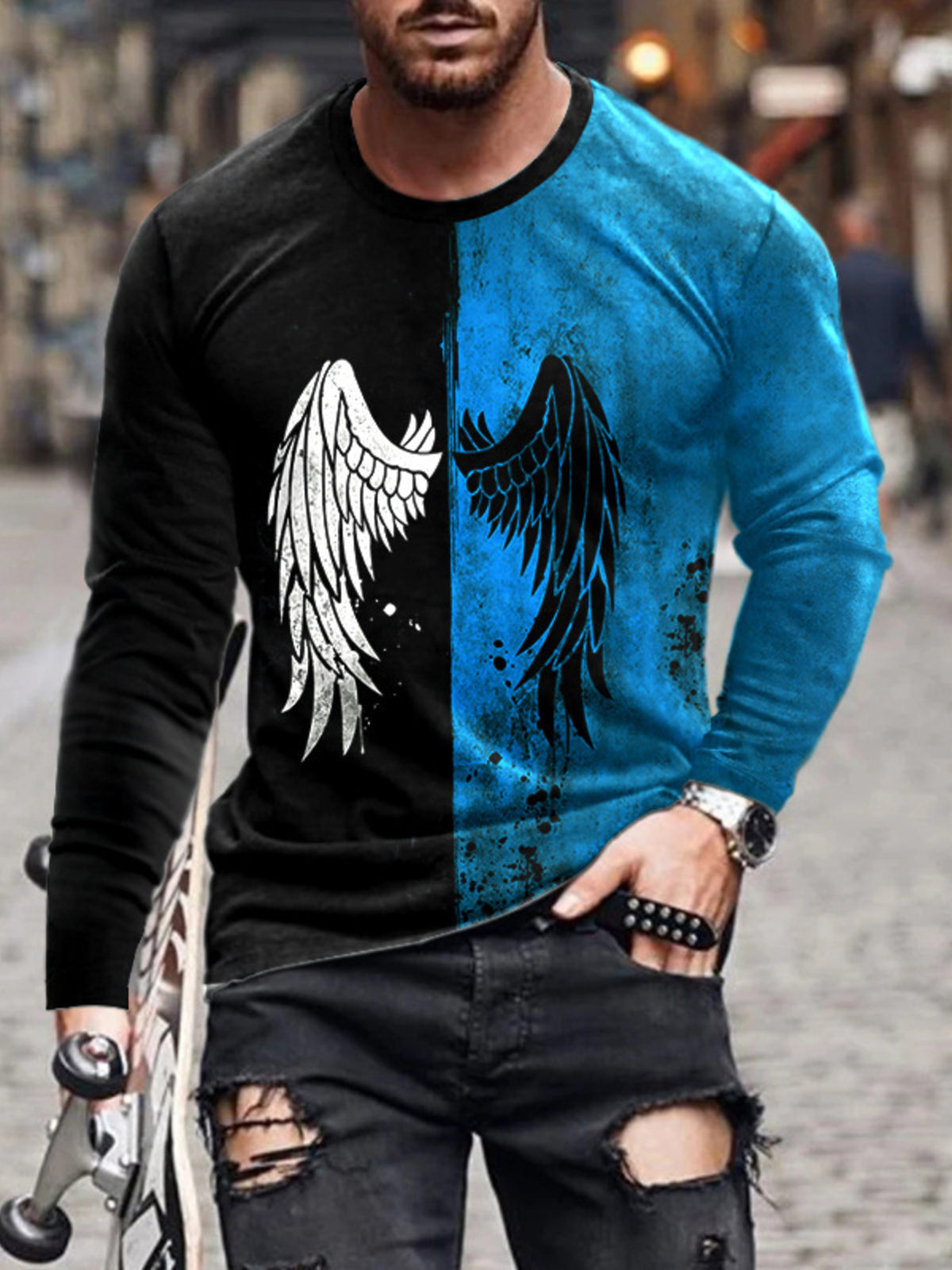 Model wearing split black and blue long-sleeve shirt with wing graphic