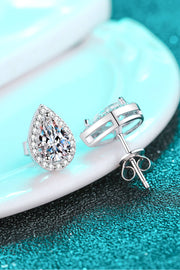 Teardrop stud earring and butterfly backs shown on a teal surface