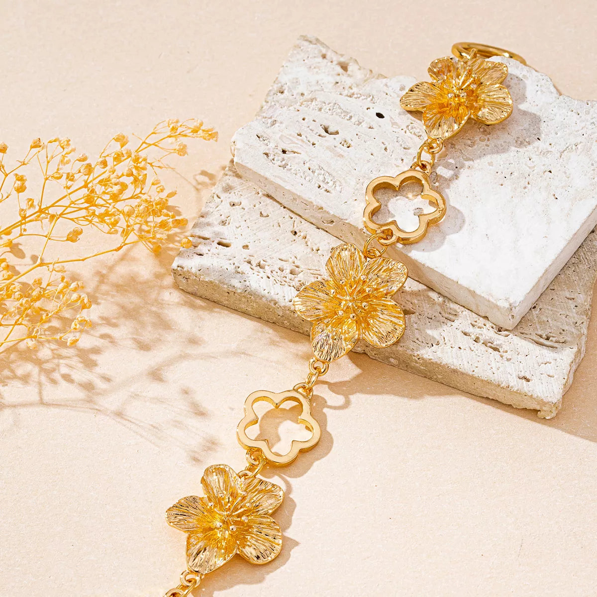 Gold-tone flower bracelet styled on a decorative box