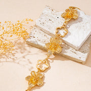 Gold-tone flower bracelet styled on a decorative box