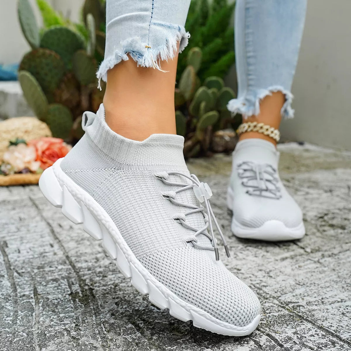 Black knit sneakers shown in outdoor setting