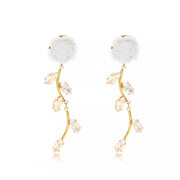 Pair of gold-tone flower drop earrings with clear accent stones, isolated view