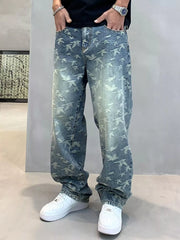 Blue bird-print jeans styled with a black top and white trainers
