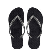 Pair of black flip-flops with silver-coloured toe-post straps, top view