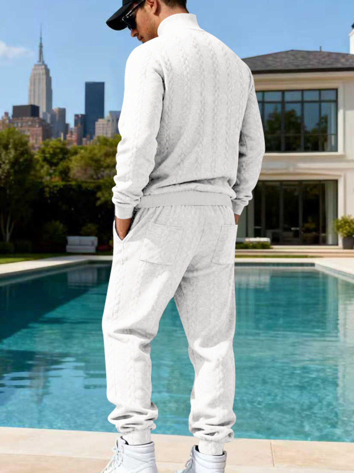 White cable-knit sweater and joggers shown from the back.