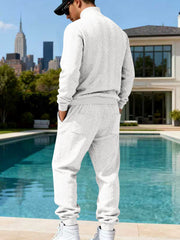 White cable-knit sweater and joggers shown from the back.