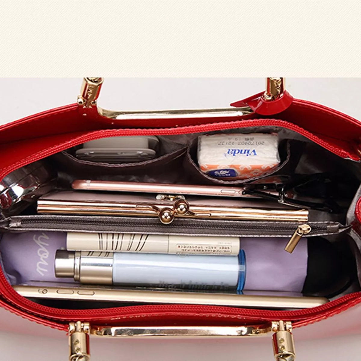 Open red handbag showing its divided interior and pockets