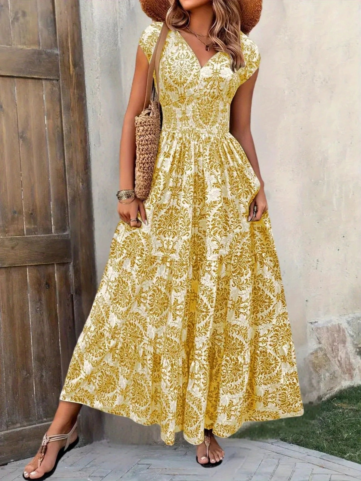 Blue floral cap-sleeve maxi dress shown from the front with a smocked waist.