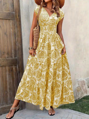 Blue floral cap-sleeve maxi dress shown from the front with a smocked waist.