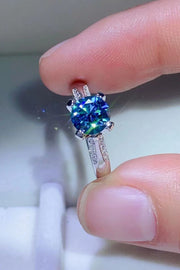 Close-up of sky-blue center stone in a four-prong ring setting