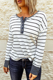 Model wearing white and black striped waffle-knit Henley with button placket