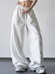 Front view of light gray wide-leg pants with script print