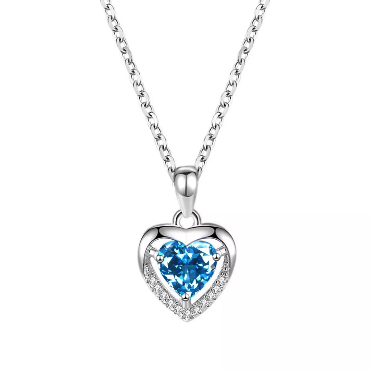 Close-up of blue heart pendant necklace on white background