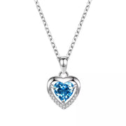 Close-up of blue heart pendant necklace on white background