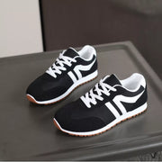Pair of black sneakers with bold white side stripes