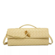 Front view of a cream woven wristlet bag with gold-tone clasp