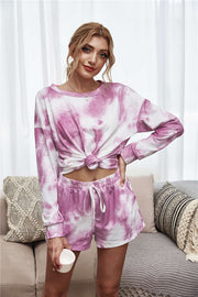 Model wearing pink tie-dye long-sleeve top and matching lounge shorts
