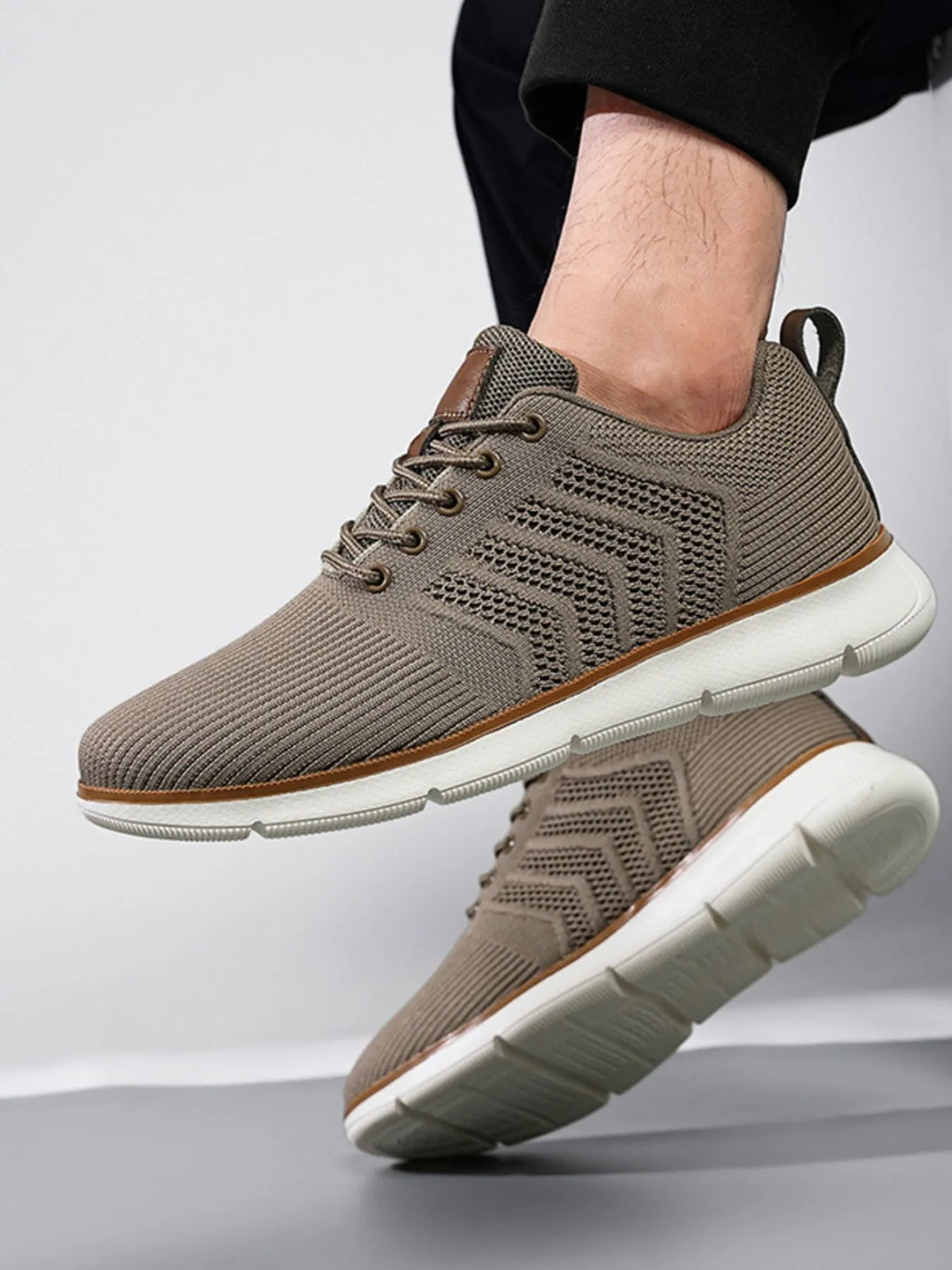 Taupe knit lace-up shoes with white segmented soles shown from the side
