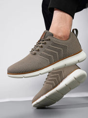 Taupe knit lace-up shoes with white segmented soles shown from the side