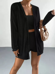 Model wearing the black ribbed three-piece set with cardigan open