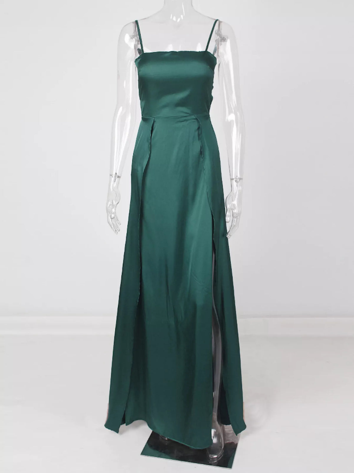 Full-length view of green high-slit spaghetti-strap maxi dress on a clear form