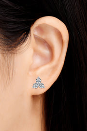 Three-stone moissanite stud earring worn on ear