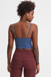Back view of a model wearing the blue cami with thin straps.