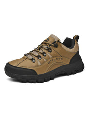 Tan lace-up shoe with black reinforced toe and heel panels, angled product view