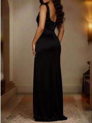 Back view of black satin maxi dress with fitted silhouette and high slit.