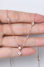 Delicate silver-tone necklace with small stones draped across a hand