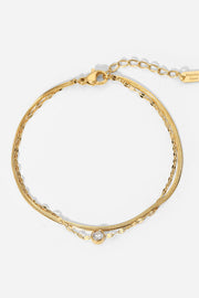 Gold-tone double-layer bracelet with a round clear rhinestone