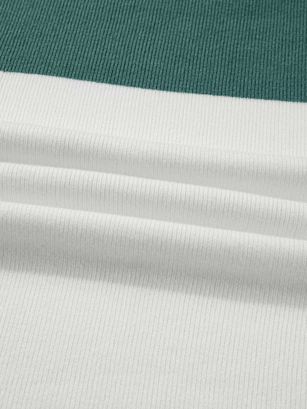 Close-up of teal and ivory rib-knit fabric