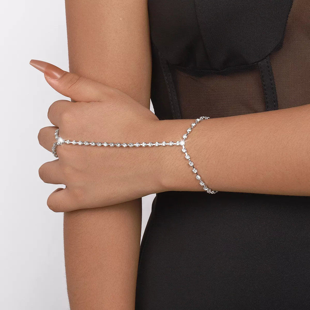 Close-up of rhinestone chain bracelet wrapped across hand