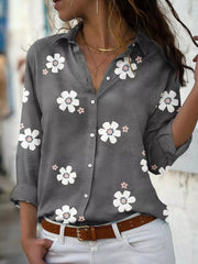 Charcoal floral button-down shirt worn with white jeans.