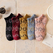 Five smiley-face ankle socks in black, burgundy, mustard, blue and pink