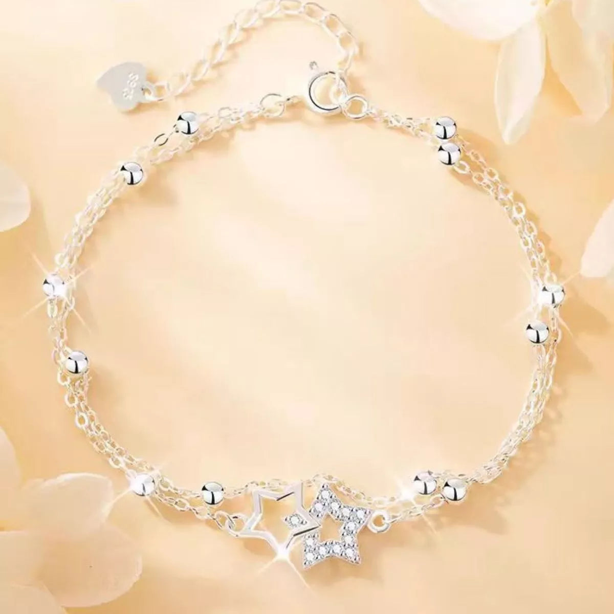 Silver star bracelet arranged in a circle with sparkling star charms