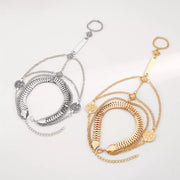 Gold and silver-tone layered chain hand bracelets displayed together