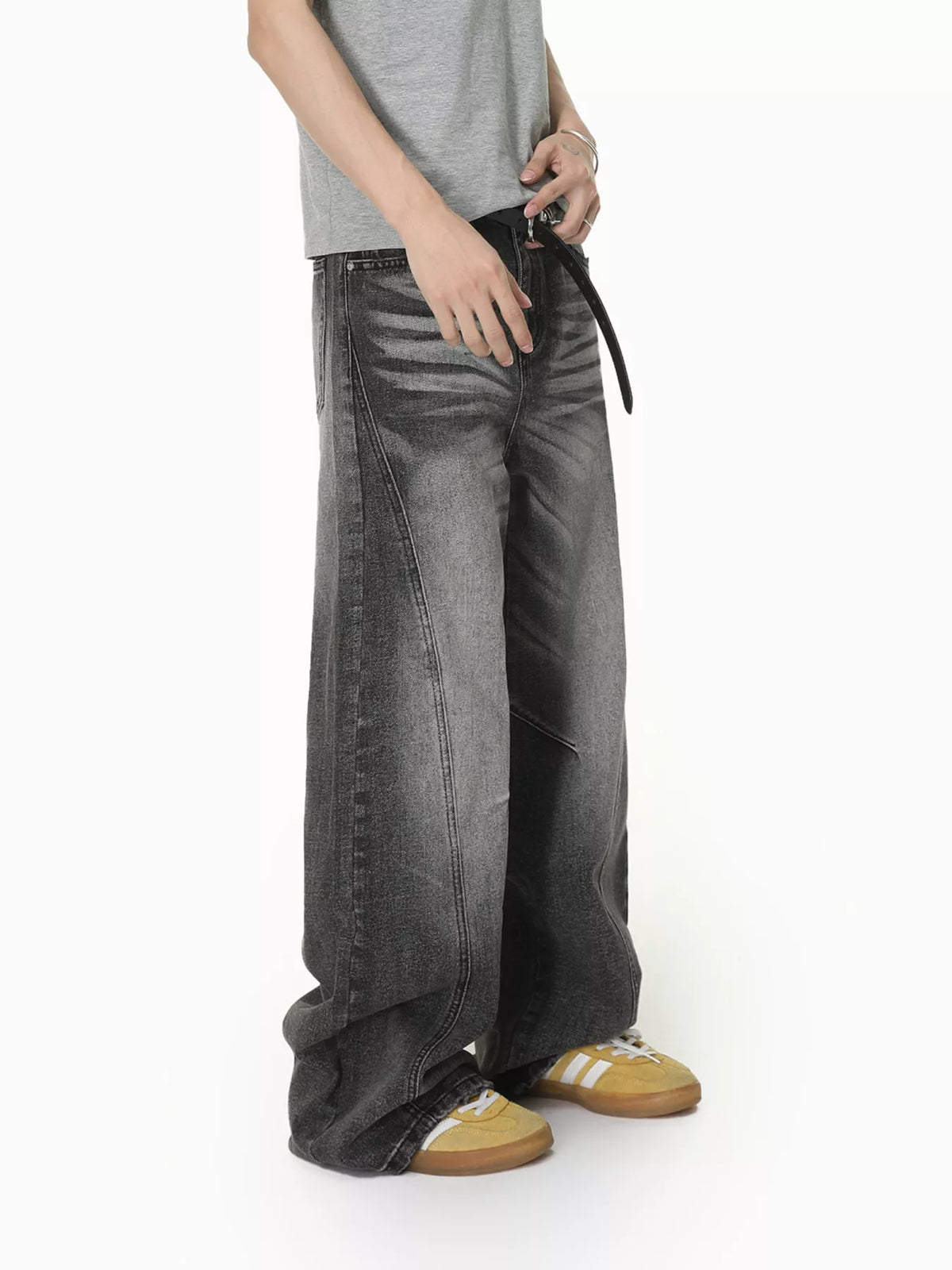 Angled view of grey wide-leg jeans showing the loose leg shape
