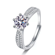 Silver moissanite solitaire-style ring with pavé split shoulders on a white background