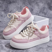Pair of pink and white platform sneakers on display