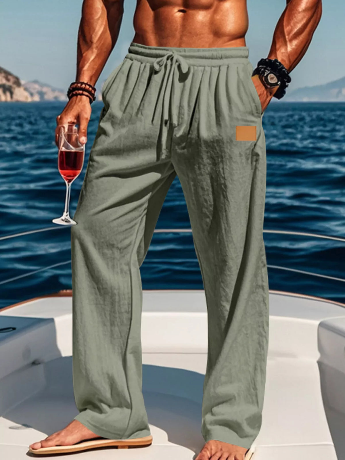 Model wearing sage green wide-leg pants by the water