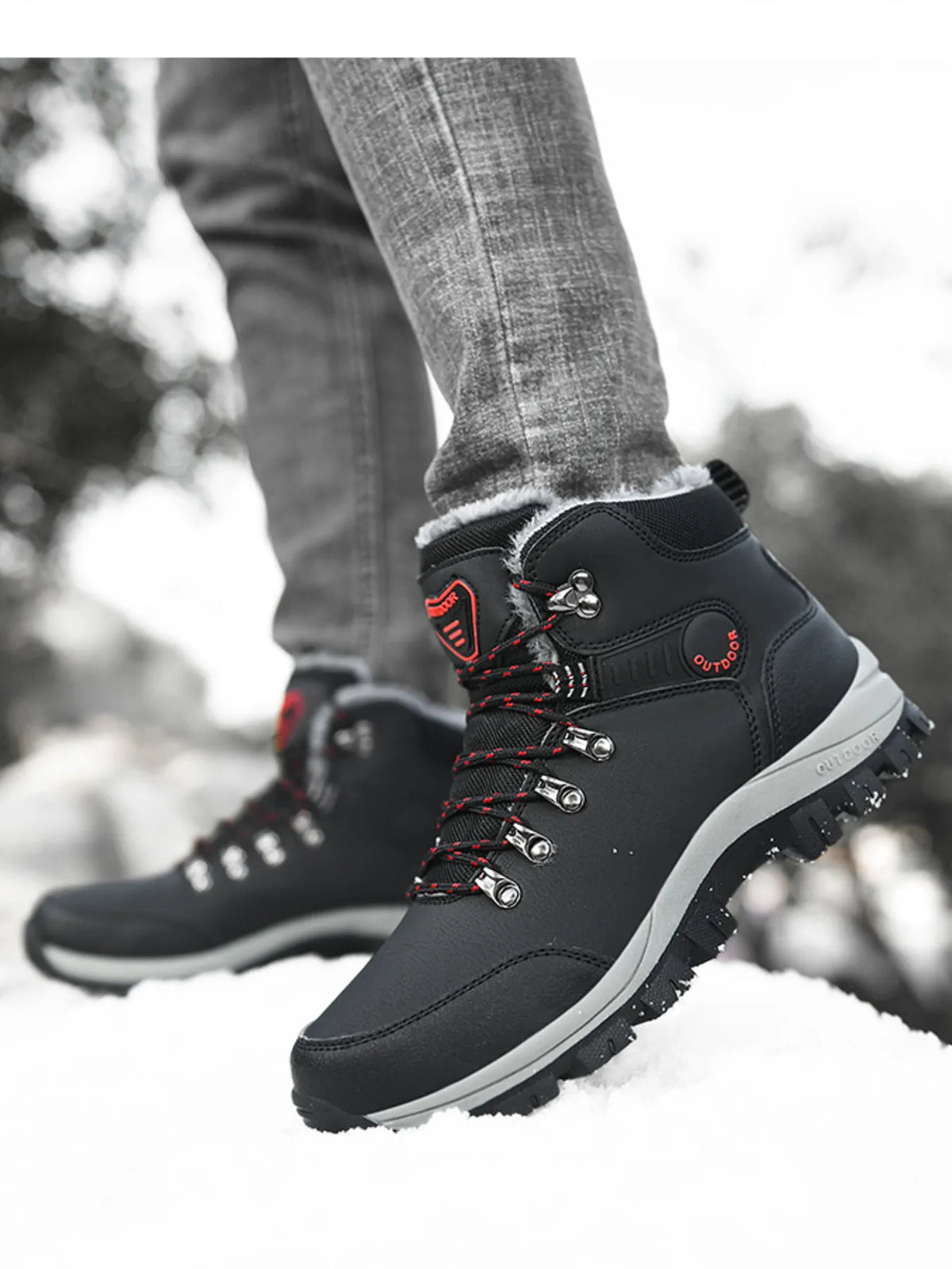 Side view of black lace-up boots showing metal lace hooks and red accents
