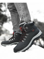 Side view of black lace-up boots showing metal lace hooks and red accents