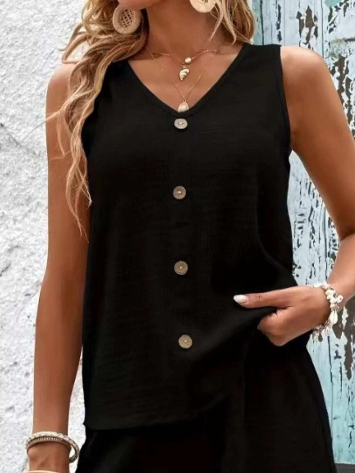 Closer front view of the black set showing the button placket and relaxed fit.