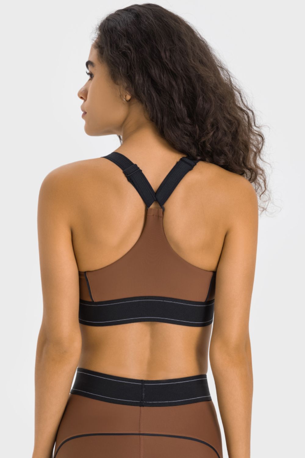 Back view of brown contrast sports bra with black racerback straps