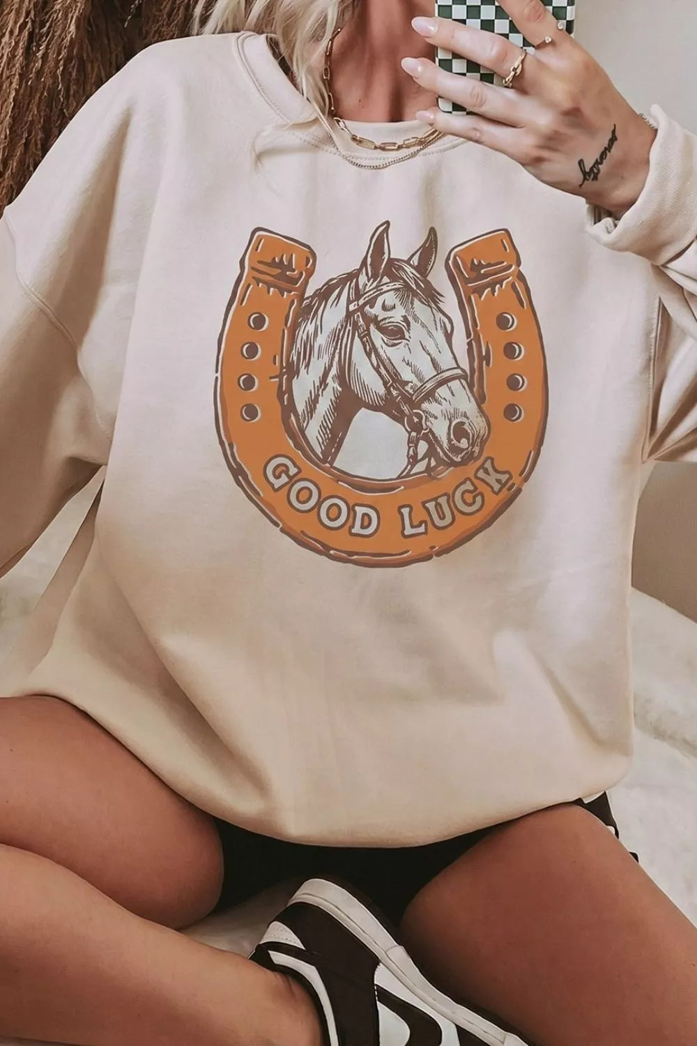 Close view of horse and good luck horseshoe chest graphic