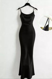 Black satin cowl-neck maxi dress with pearl straps displayed on a hanger.