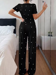 Rear view of black heart-print short-sleeve lounge top and matching lettuce-trim pants