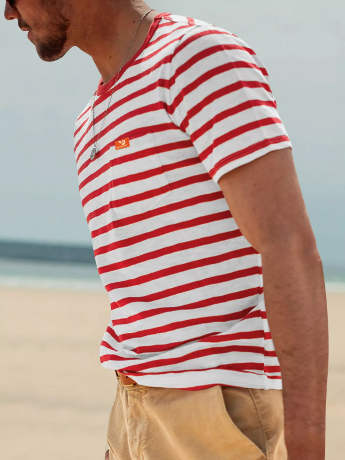 Side view of model wearing red-and-white striped T-shirt
